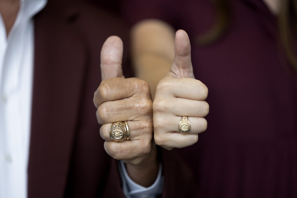 Two individuals with Aggie Rings to represent the strong tradition of the Aggie Core Values