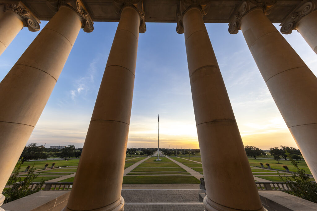 Administration building columns overlooking the flag on New Main Dr.