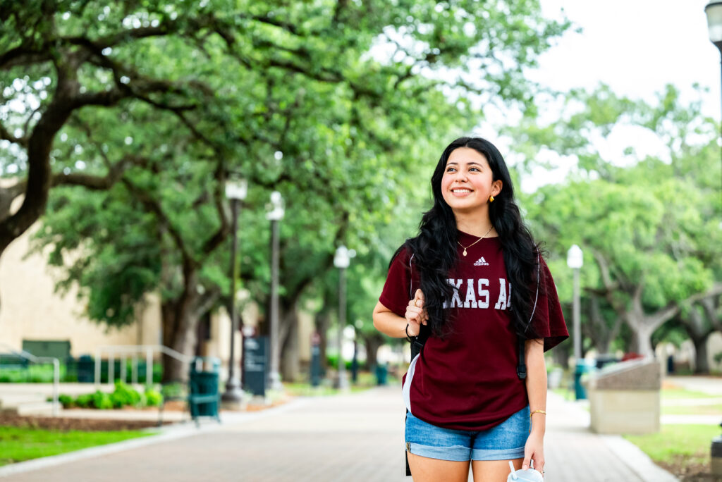 Student walking Academic Plaza and Military Walk in College Station, Texas by Whitney Moody, Texas A&M University Division of Marketing & Communications